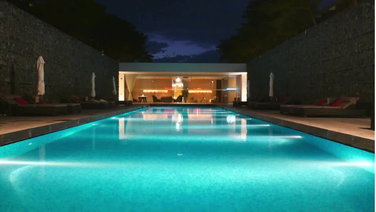 Clear illuminated swimming pool at night